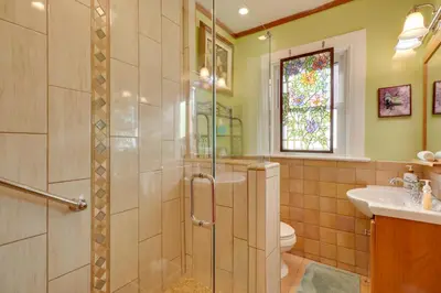 a bathroom with a shower and a toilet and a sink at Steps to Truckee River Walk Rose Cottage in Reno