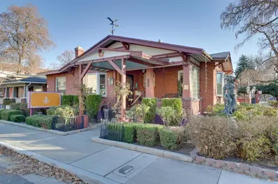 a house with a statue in front of it at Steps to Truckee River Walk Rose Cottage in Reno