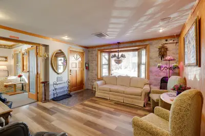 a living room with a couch and a table and chairs at Steps to Truckee River Walk Rose Cottage in Reno