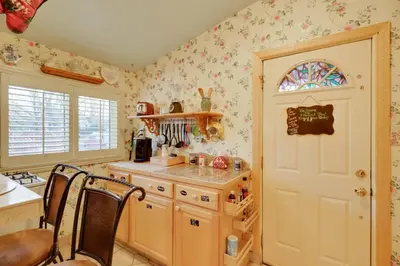 a kitchen with a table and chairs and a door at Close to Midtown! Cozy Reno River Cottage in Reno