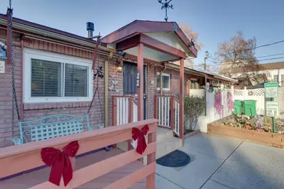a house with a porch with a bow on it at Close to Midtown! Cozy Reno River Cottage in Reno