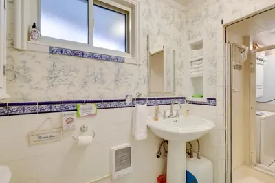 a bathroom with a sink and a mirror at Close to Midtown! Cozy Reno River Cottage in Reno