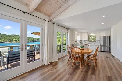 a kitchen and dining room with a table and chairs at Lakefront Villa with 180 degree view private dock and boats in Groveland