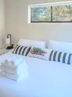 a bedroom with a white bed with towels on it at Lakefront Villa with 180 degree view private dock and boats in Groveland