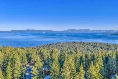 an aerial view of a forest of trees and water at Beautiful Homewood Retreat with Deck and Grill in Homewood