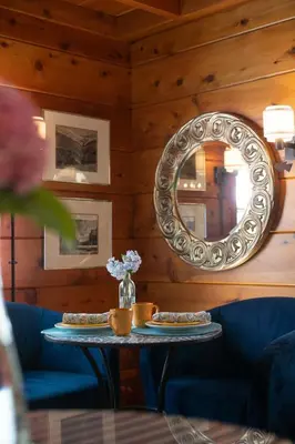 a mirror and a table with two pizzas on it at Elliott House Boutique Inn in Shaver Lake