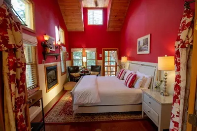 a bedroom with red walls and a bed in a room at Elliott House Boutique Inn in Shaver Lake