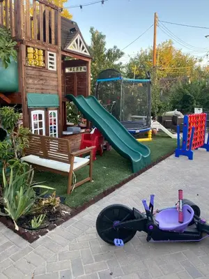 a playground with a slide and a play set at English Rose Garden Cottage near Roseville, CA in Citrus Heights
