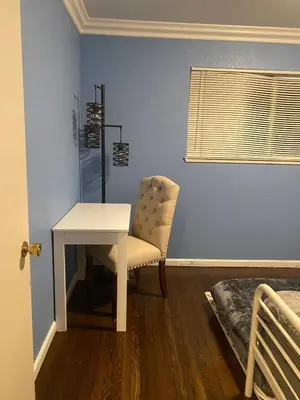 a room with a table and a chair and a bed at English Rose Garden Cottage near Roseville, CA in Citrus Heights