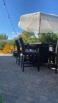 a picnic table with chairs and an umbrella at English Rose Garden Cottage near Roseville, CA in Citrus Heights