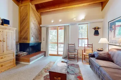 a living room with a couch and a fireplace at Getaway at Gold Bend in Ponderosa Fairway Estates