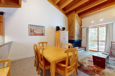 a dining room with a wooden table and chairs at Getaway at Gold Bend in Ponderosa Fairway Estates