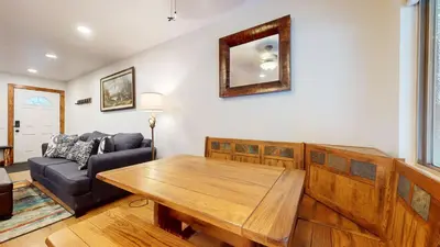 a living room with a wooden table and a couch at Meridian Villas #10 condo in Mammoth Lakes