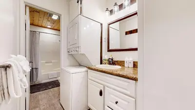 a white bathroom with a sink and a mirror at Meridian Villas #10 condo in Mammoth Lakes