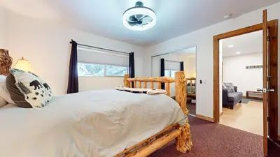 a bedroom with a large bed and a mirror at Meridian Villas #10 condo in Mammoth Lakes
