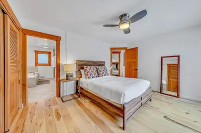 a bedroom with a bed and a ceiling fan at Stunning Mountain Gem with Hot Tub Near Palisades in Olympic Valley