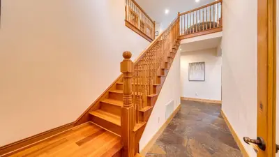 a staircase in a home with wooden treads at 5 mins to Ski Resort Ping Pong Pool Table Deck Donner Ridge by AvantStay in Truckee