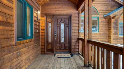 a wooden front door of a log house at 5 mins to Ski Resort Ping Pong Pool Table Deck Donner Ridge by AvantStay in Truckee