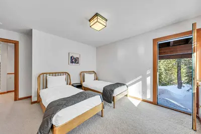 two beds in a room with a window at Pet-Friendly Home, Deck, 1 Mile to Alpine Meadows in Alpine Meadows