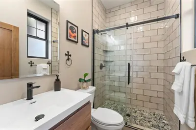a bathroom with a sink and a toilet and a shower at Luxury Living Modern Midtown Ensuite Baths Patio in Reno