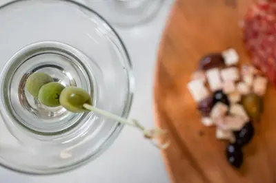 a glass of wine with grapes on a cutting board at Luxury Living Modern Midtown Ensuite Baths Patio in Reno