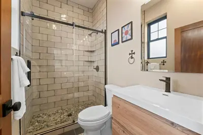 a bathroom with a toilet and a sink at Luxury Living Modern Midtown Ensuite Baths Patio in Reno