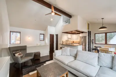 a living room with a couch and a table at Valley View Townhome # 10 at Palisades by Tahoe Getaways - Shuttle & Walk to the Village! in Olympic Valley