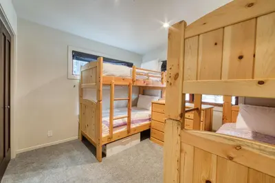 a bedroom with two bunk beds in a house at Valley View Townhome # 10 at Palisades by Tahoe Getaways - Shuttle & Walk to the Village! in Olympic Valley