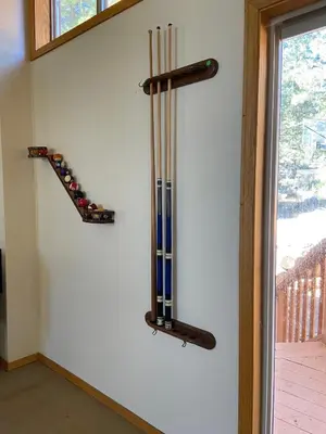 a wall with a bunch of hockey sticks on a wall at 6000 sqft Pine House with indoor swimming pool in Reno