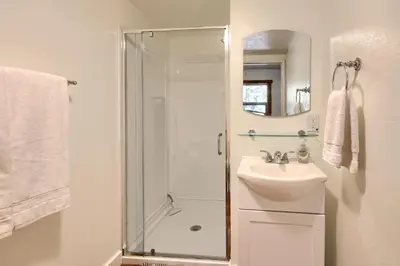a bathroom with a shower and a sink at Tranquility House-Riverfront-Fireplace-Sleeps six in Oakhurst