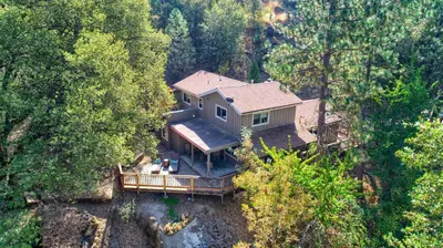 an aerial view of a house in the forest at Tranquility House-Riverfront-Fireplace-Sleeps six in Oakhurst