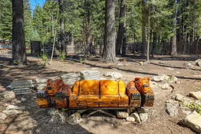 a couch carved into the shape of tigers in a forest at Tahoe Dreamer by Tahoe Getaways - Pet Friendly 4 BR Gated Home w Fenced Yard, Game Room & Walk to Lake! in Carnelian Bay