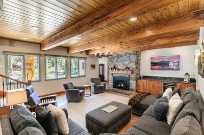 a living room with a couch and a fireplace at Tahoe Dreamer by Tahoe Getaways - Pet Friendly 4 BR Gated Home w Fenced Yard, Game Room & Walk to Lake! in Carnelian Bay