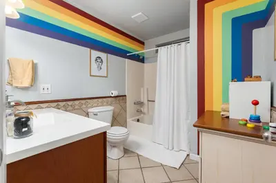 a bathroom with a rainbow painted on the ceiling at Immersive Stranger Things Experience in Clovis
