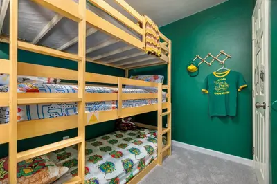 a bunk bed room with green walls and wooden bunk beds at Immersive Stranger Things Experience in Clovis