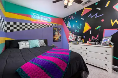 a bedroom with a bed with a colorful wall at Immersive Stranger Things Experience in Clovis