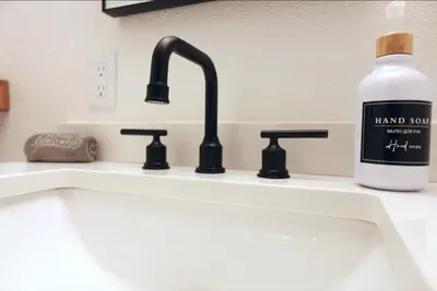 a bottle of hand soap sitting next to a sink at Stunning Waterfront 3BR Retreat - Perfect Getaway in Discovery Bay
