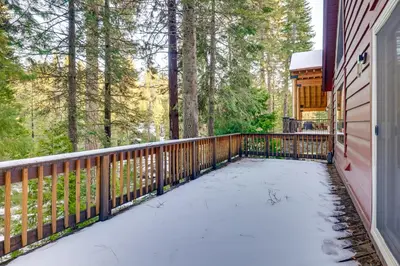 a deck covered in snow next to a house at 5 Mi to Dodge Ridge Cabin in Strawberry in Strawberry