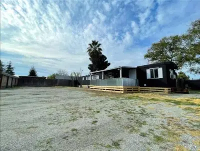 a home with a large yard with a house at Nifty Trailer With Spacious Parking in Visalia