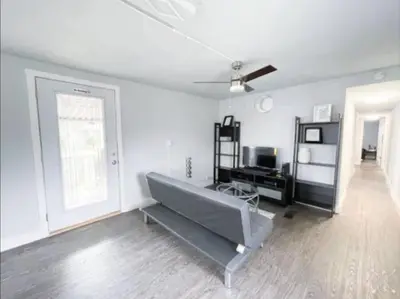 a living room with a couch and a television at Nifty Trailer With Spacious Parking in Visalia