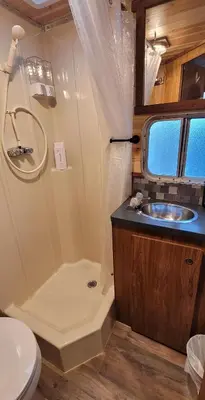a bathroom with a shower and a sink and a toilet at Cozy Farm Stay for Two in Three Rivers
