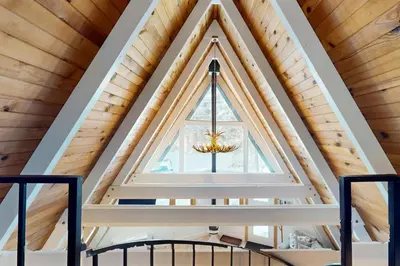 a window in the roof of a cabin with a chandelier at Elati Escape in South Lake Tahoe