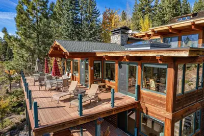 a large wooden deck with chairs on it at Clouds Rest in Dollar Point By Tahoe Getaways - Lake views - Hot Tub & Game Room in Tahoe City