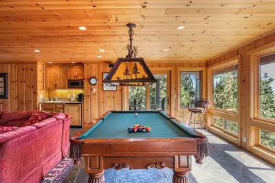 a living room with a pool table in a house at Clouds Rest in Dollar Point By Tahoe Getaways - Lake views - Hot Tub & Game Room in Tahoe City