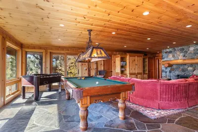 a living room with a pool table and a piano at Clouds Rest in Dollar Point By Tahoe Getaways - Lake views - Hot Tub & Game Room in Tahoe City