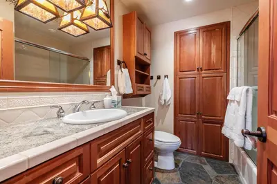 a bathroom with a sink and a toilet and a mirror at Clouds Rest in Dollar Point By Tahoe Getaways - Lake views - Hot Tub & Game Room in Tahoe City
