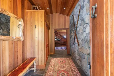 a hallway in a cabin with a stone wall at Clouds Rest in Dollar Point By Tahoe Getaways - Lake views - Hot Tub & Game Room in Tahoe City