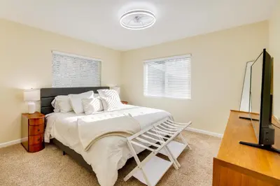 a bedroom with a bed and a television in it at Fire Pit and Grill Retreat Between Arnold and Murphys in Hathaway Pines