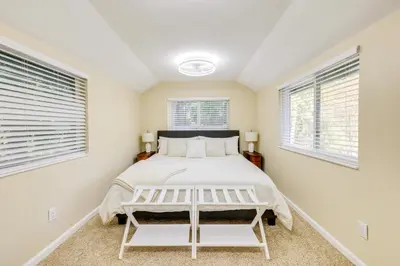 a bedroom with a bed and two windows at Fire Pit and Grill Retreat Between Arnold and Murphys in Hathaway Pines