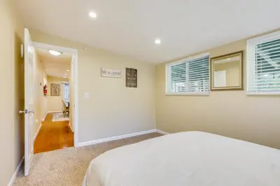 a bedroom with a bed and two windows at Fire Pit and Grill Retreat Between Arnold and Murphys in Hathaway Pines